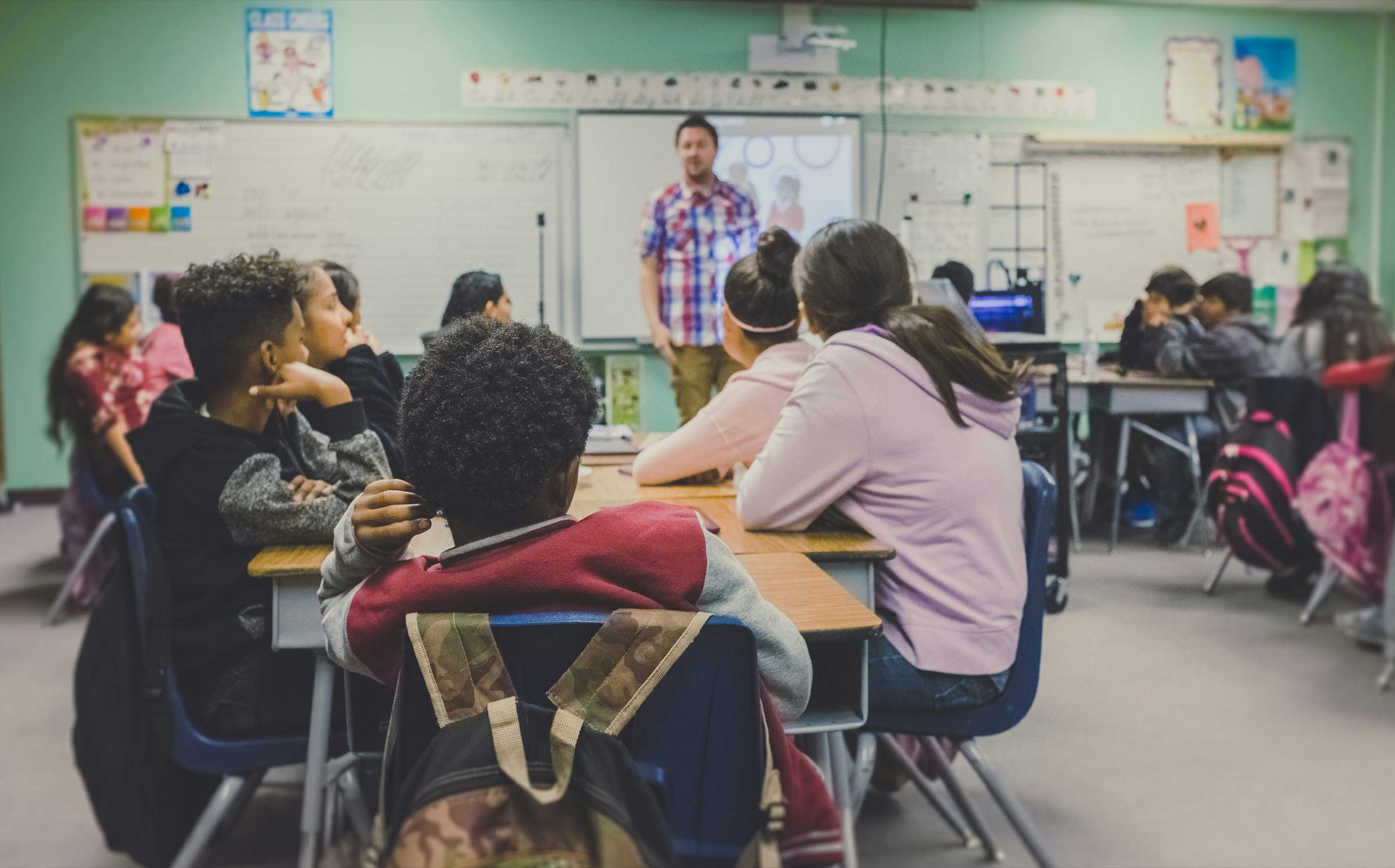 A teacher with pupils in a bright classroom